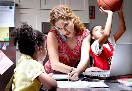 mother multitasking while 2 daughters distract her