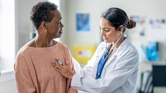 Physician checking patient's heart rate