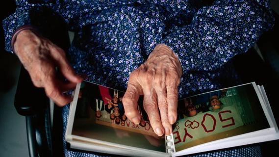 Older woman holding photo album