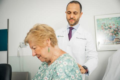 Dr. Costandi examining back of female patient