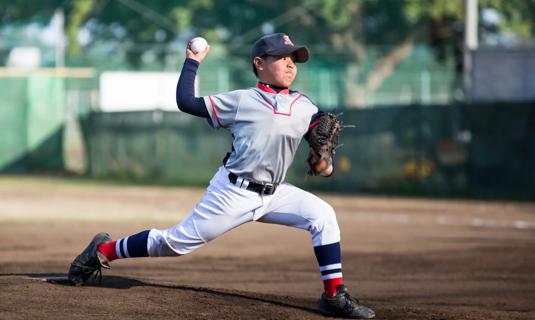 Child on baseball mound pitching