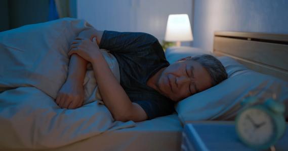 Person sleeping on their left side in bed
