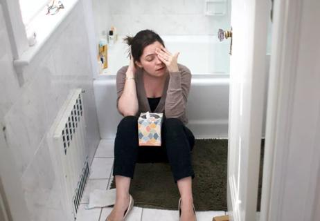 woman in bathroom sick on floor