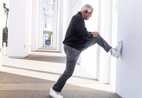 elderly man stretcing legs