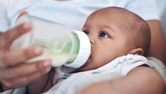 Baby being fed from a plastic bottle