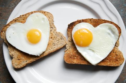 Heart-shaped soft-fried eggs on wheat toast