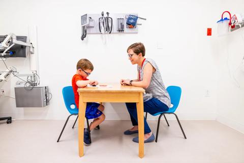 Clinician with child at table