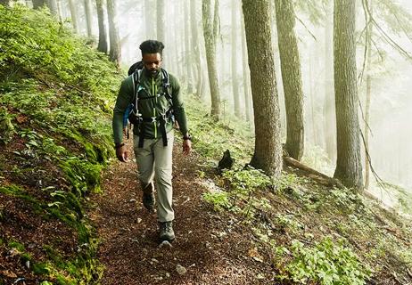 Man hiking by himself in the woods