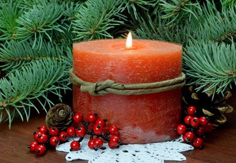 scented buring candle and evergreens