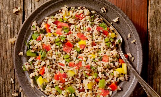 Rugged plate of mexican rice pilaf with fork on wooden table