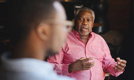 Older man talking with family member