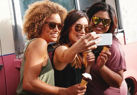 Three friends of different body types taking a selfy