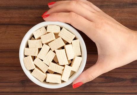 bowl of soy-based cubes with hand