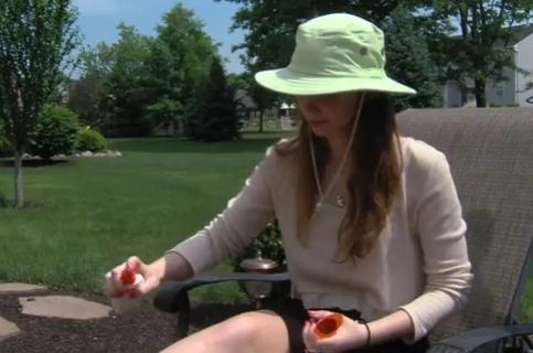 Woman using bug spray