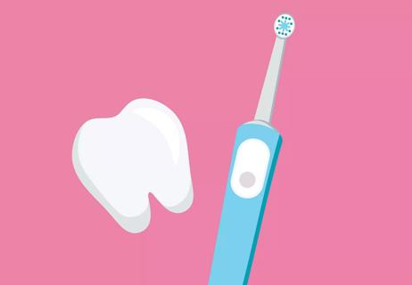 Electric toothbrush next to a tooth.