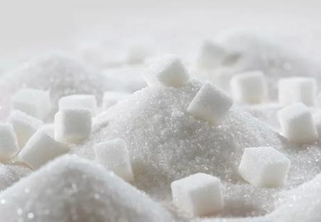 Closeup up of a pile of sugar with sugar cubes on top.