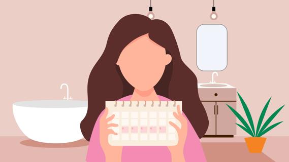 Woman in bathroom holding calendar with marked dates