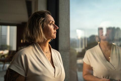 Older woman looking out window