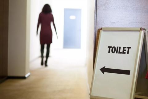 Woman rushing to bathroom