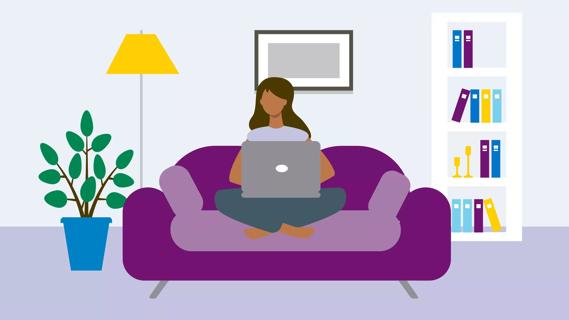Female sitting on couch with laptop on lap