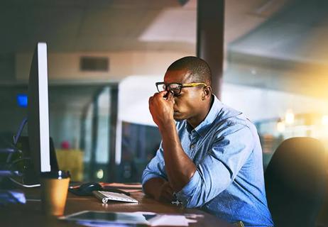 Man at work with migraine caused by stress