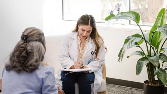 doctor speaking with middle-age woman