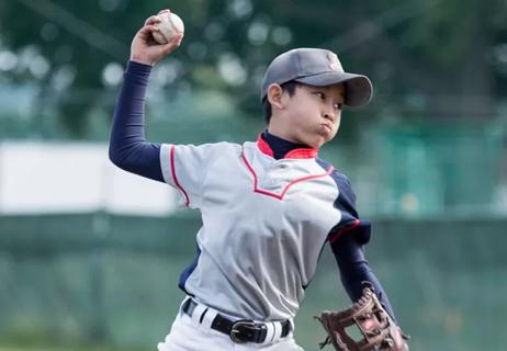 Young teen pitcher caught mid throw at plate