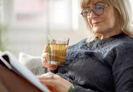 Person drinking Xiao Yao San tea and reading.