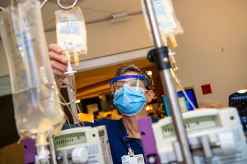 Nurse conducts safety check on medications in hospital hallway