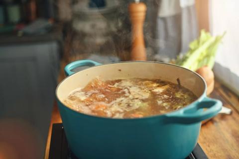 Pot of broth boiling on stove