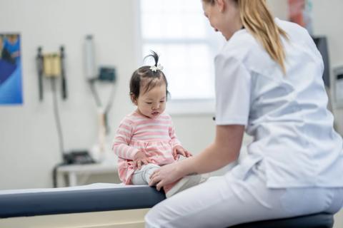 Healthcare provider examining a child in medical office