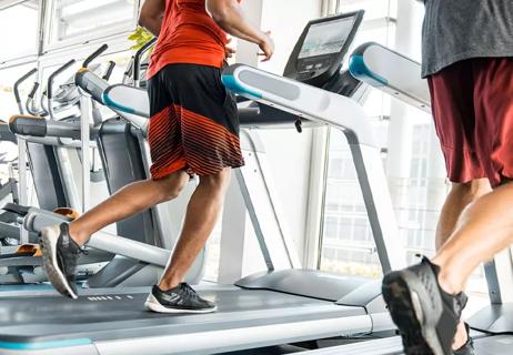 Adult running on treadmill to cushion their knees.