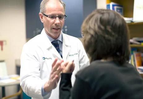 photo of doctor performing neurologic exam on a patient