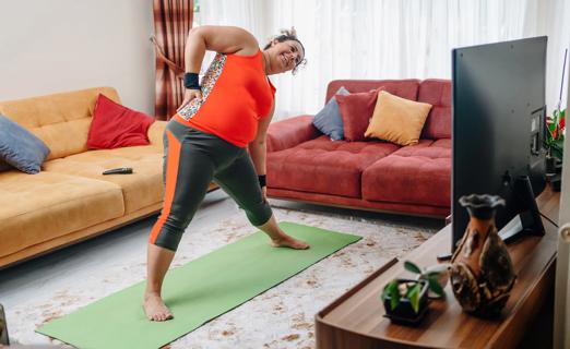 Pregnant woman exercising in living room