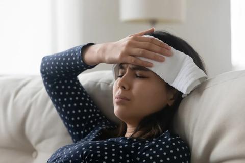 Person in distress holding a cloth over their head