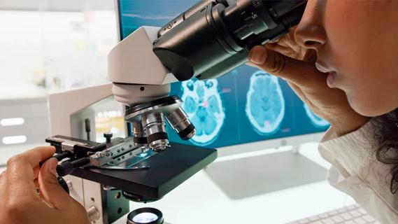 Researcher with microscope