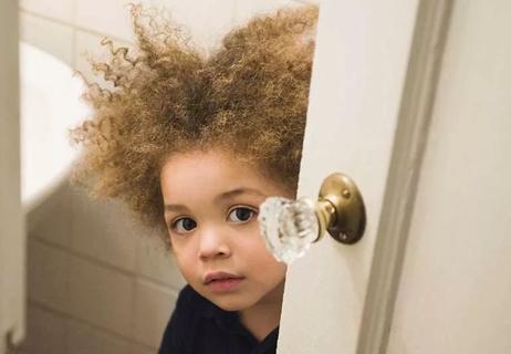 child walking out of bathroom