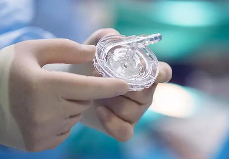 Hands holding a clear circular device