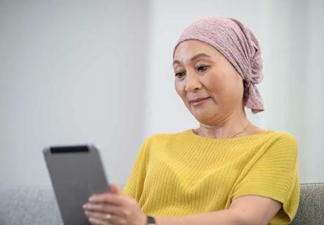 An immunocompromised person in living room on a tablet device.