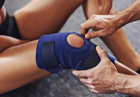 Nurse applying knee brace