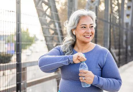 woman walking and drinking water