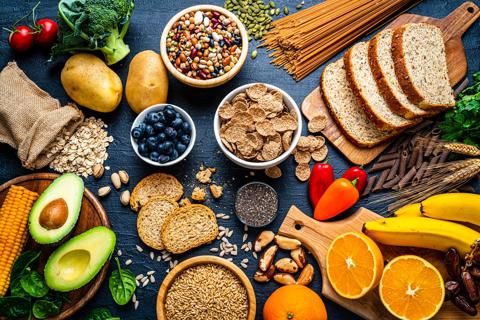 Assorted healthy foods spread out over a table and cutting boards