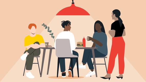 Four people eating and talking, with one person sitting slightly aloof from the others