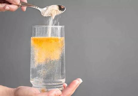 spoonful of fiber added to a glass of water