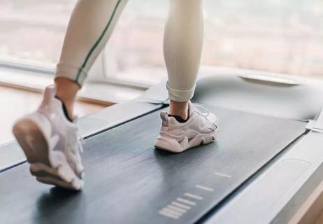 Woman walking on a treadmill.