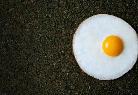 Fired egg on hot pavement