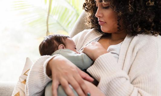 Mother gazing down at baby while breastfeeding