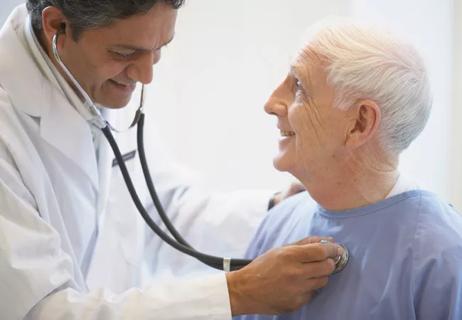Physician using stethoscope to listen to a patient’s heart