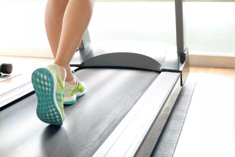 leg of woman running on treadmill in the gym which runner athletic by running shoes. Health and sport concept background,