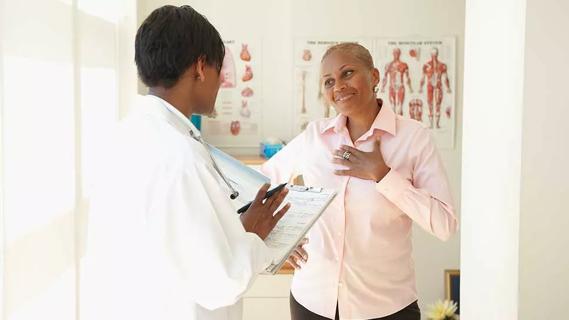 healthcare provider speaking with older female in office